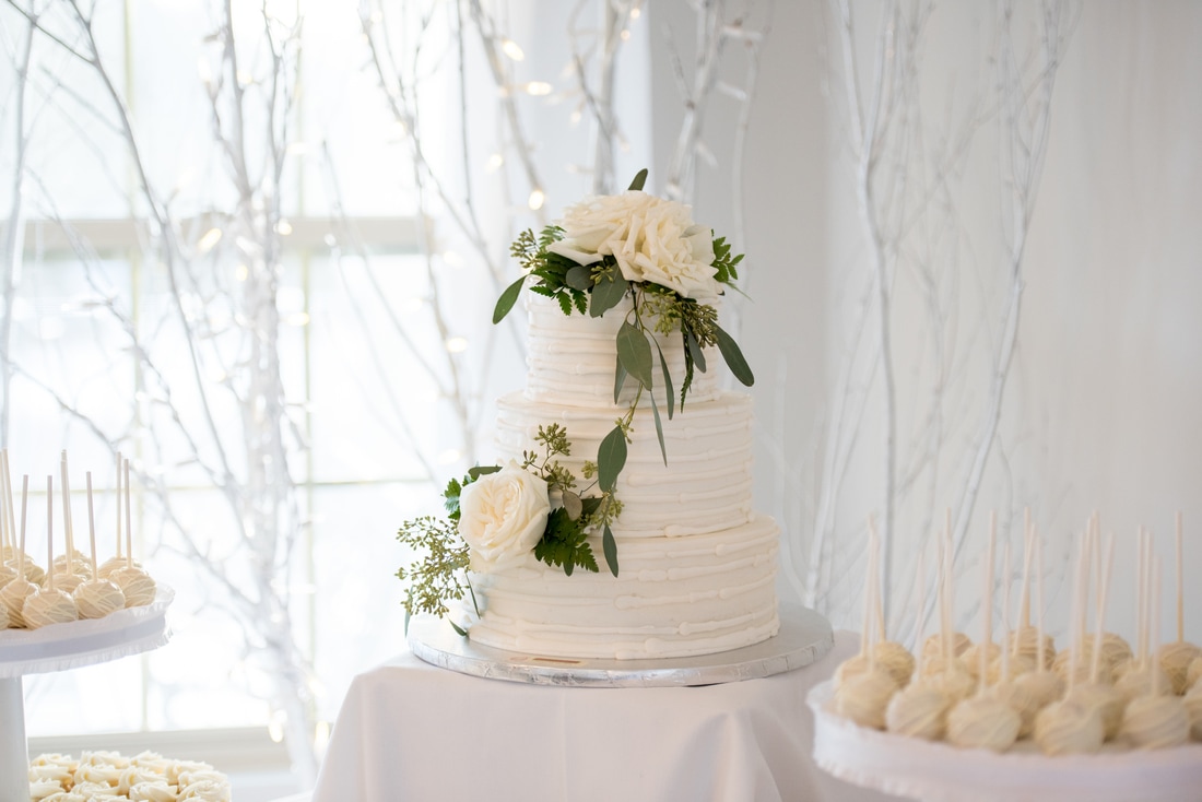 Stunning wedding cake in cream with beautiful flowers