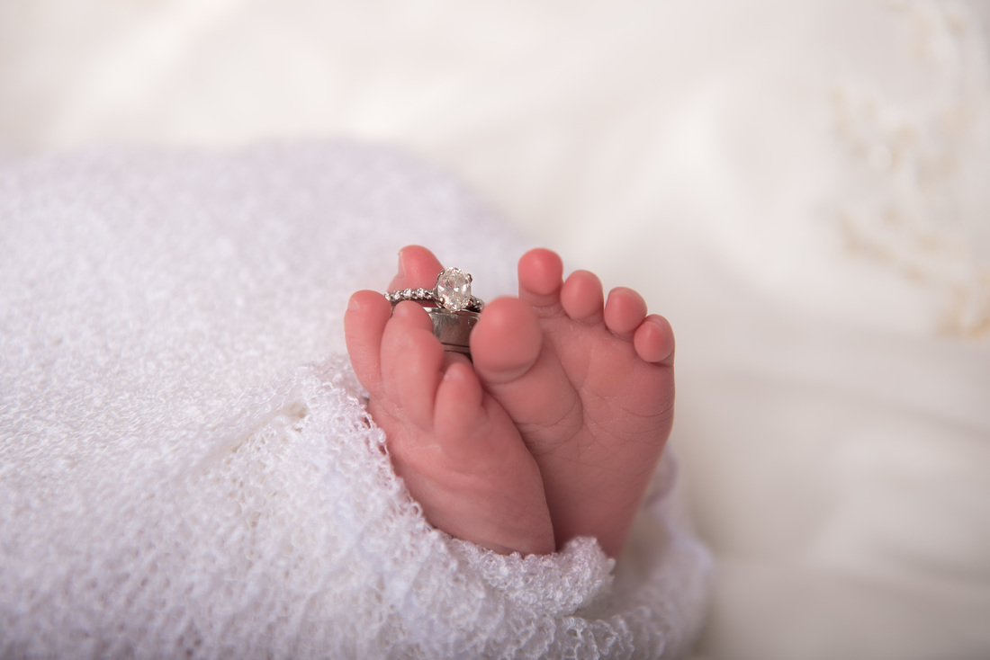 Newborn toes with wedding rings photography session