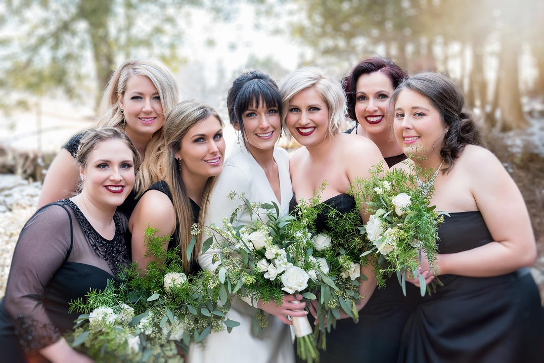 Beautiful bride with the wedding party and bridal flowers
